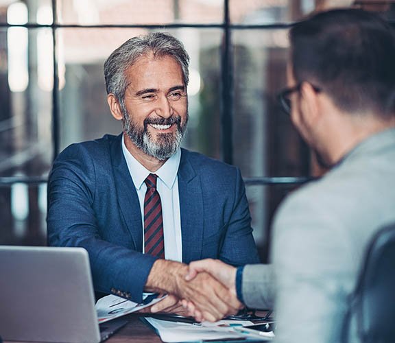 Man with gray hair being interviewed