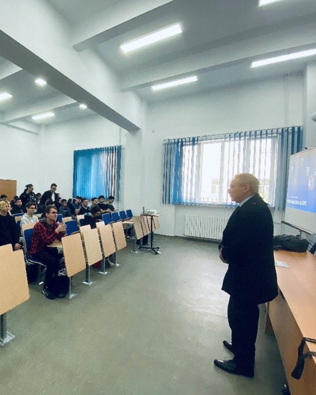 Alexandru Dragomir, SPE Romania section chair, presenting to student in Iași