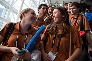 student members riding an escalator